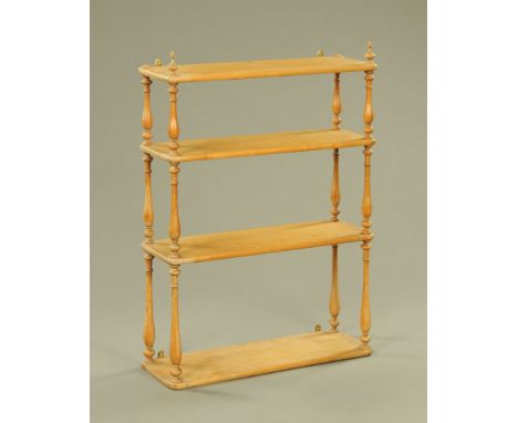 A light oak four tier wall shelf, of Victorian design, with slender baluster turned supports, 106 cm high x 77 cm wide x 26 c