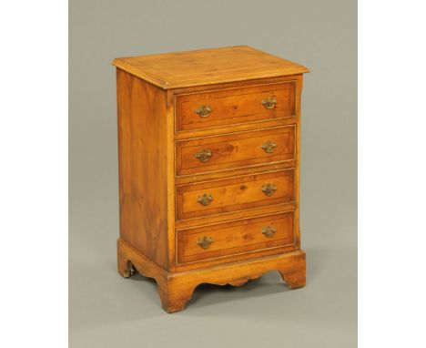 A George III style reproduction yew wood chest of four drawers, with brass drop handles and cockbeading to each drawer front 