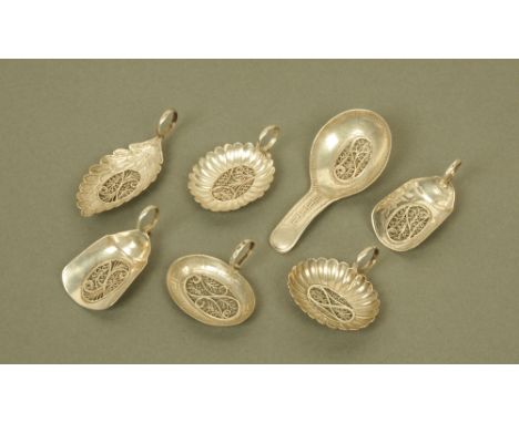 A group of seven George III silver caddy spoons by Samuel Pemberton, displaying different shapes and designs and all with fil