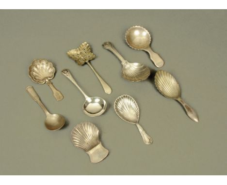 An early 19th century white metal Fiddle pattern caddy spoon, with circular crenellated bowl, with spurious hallmarks (possib
