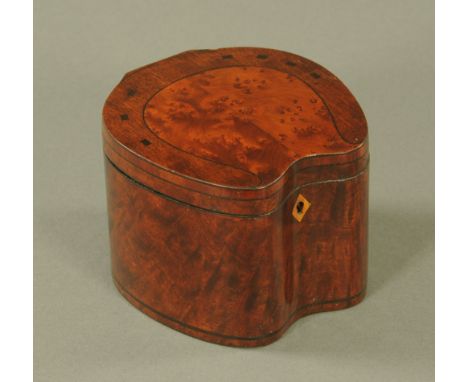 A George III figured mahogany and amboyna veneer horseshoe shaped tea caddy.  9.5 cm high.