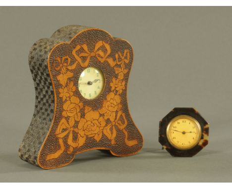 A vintage pokerwork cased timepiece.  Height 19 cm, together with a tortoiseshell mounted easel backed travel clock.