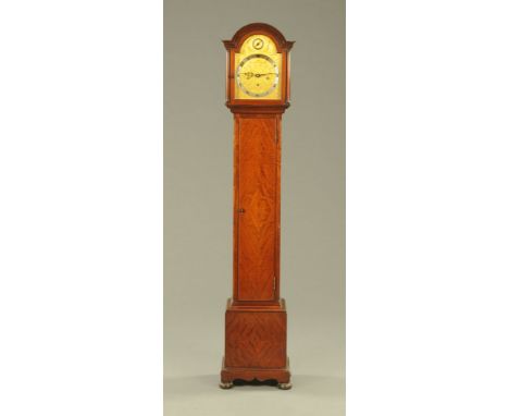 A 1920's figured mahogany cased grandmother clock, the 21 1/2" engraved brass dial with silvered chapter ring and strike sile