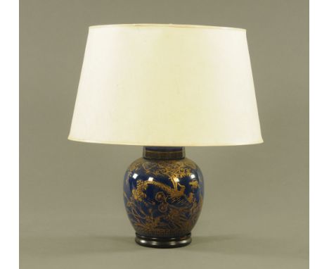 A 20th century ginger jar form electric table lamp decorated in gilt with flowers and repeating borders against a mottled cob