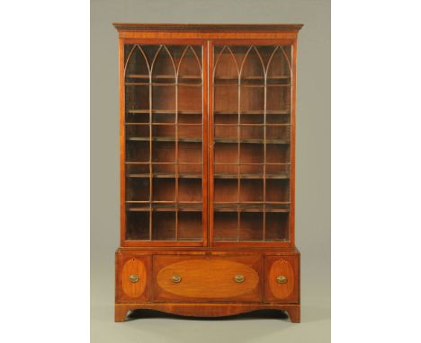 A Georgian mahogany bookcase, with detachable dentil cornice above a pair of glazed doors with wooden astragals enclosing adj