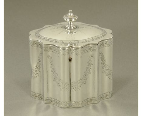 A George III silver tea caddy by William Plummer, of shaped oval outline, with urn finial and engraved throughout with floral