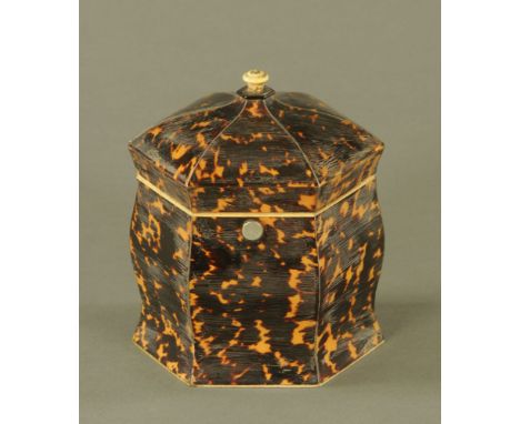 An early 19th century tortoiseshell hexagonal tea caddy, with ivory finial and shaped body. 14 cm high. CONDITION REPORT: Thi