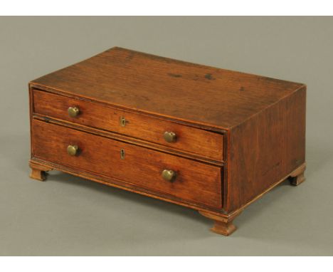 A George III mahogany two drawer cabinet, on ogee feet, 16 cm x 37 cm x 24 cm. CONDITION REPORT: This cabinet is in good over
