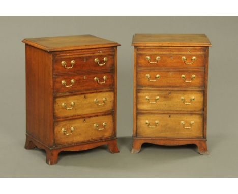 A pair of reproduction mahogany bedside chests each with brushing slide over four graduated cockbeaded drawers each with bras