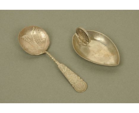 An unusual Indian white metal oval caddy spoon by Hamilton & Co Calcutta with coin handle, together with a Chinese white meta