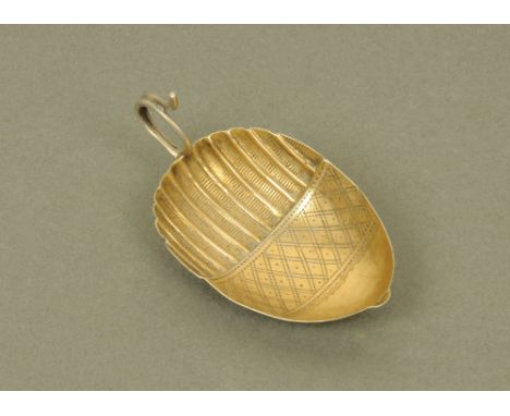 A George III silver and silver gilt caddy spoon by John Thropp or Joseph Taylor, with reeded and lozenge engraved acorn patte