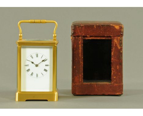 A brass carriage clock, with two train movement striking on a gong.  Height excluding carrying handle 13 cm, complete with ke