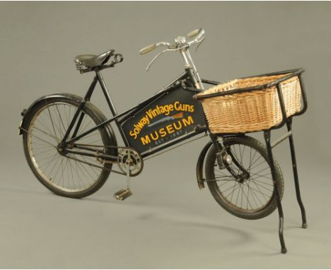 Gundle a vintage shop bike with basket to front and signwritten for Solway Vintage Guns Museum, established 1987, the opposit