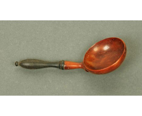 A late 18th/early 19th century finely carved yew wood caddy spoon, with circular bowl and ebonised terminal.