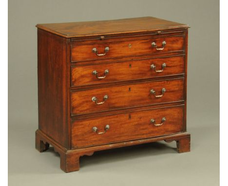 A George III mahogany chest of drawers, with slide above four long graduated drawers with brass drop handles and raised on br