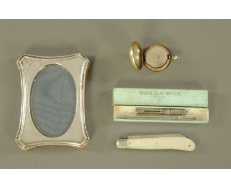 A small silver photograph frame, with oval aperture, together with a swizzle stick, fruit knife etc.