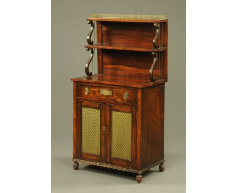 A small 19th century rosewood chiffonier, with brass gallery, tiered shelves and fitted with a drawer above a pair of cupboar