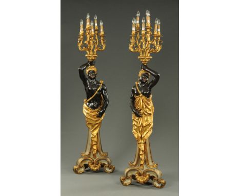 A pair of large Blackamoor lamp standards, painted composition.  Height to highest point 220 cm. CONDITION REPORT: These lamp