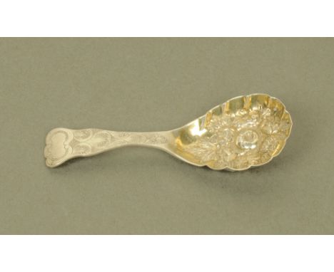 A Victorian silver caddy spoon by George Unite, with leaf scroll engraved terminal and floral embossed silver gilt bowl, Birm