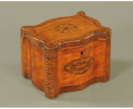 A George III mahogany tea caddy of serpentine outline, inlaid with rosewood crossbanding, roundel and shell paterae and herri