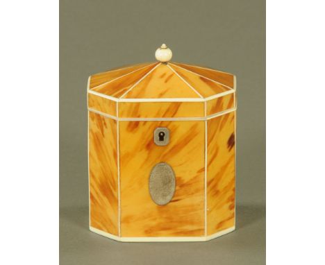 A George III blond tortoiseshell octagonal tea caddy, the angled top with ivory ball finial and inlaid with ivory stringing, 