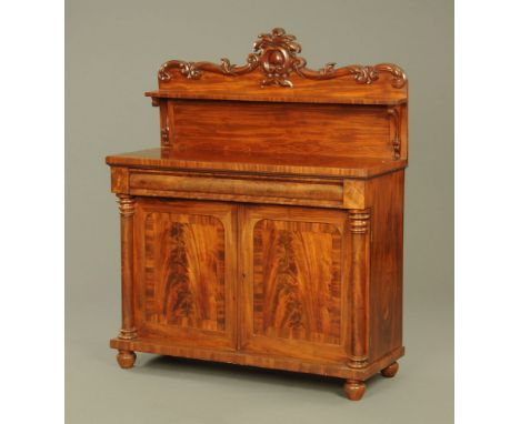 An early Victorian figured mahogany chiffonier, with leaf moulded back, fitted single frieze drawer, cupboard under enclosed 