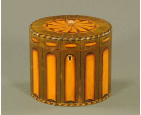 An inlaid and green stained wood oval tea caddy of Georgian style, decorated with paterae to lid and simulated reeded sides. 