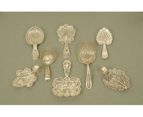 Eight early 19th century filigree white metal caddy spoons, of varying designs, two with engraved cartouche. CONDITION REPORT