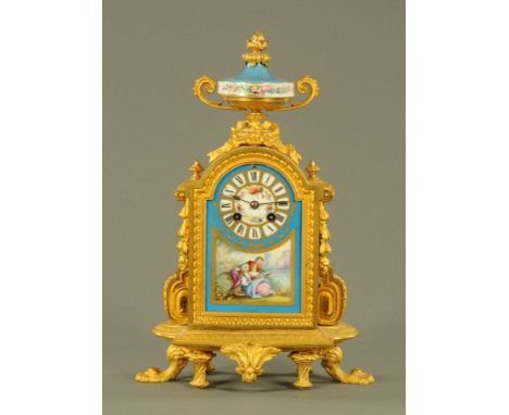 A 19th century French ormolu and porcelain panelled mantle clock, with key and pendulum and with two train movement, the dial