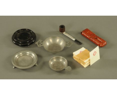 A mixed lot comprising pewter tastevin, 12 cm long, a two handled pewter tastevin, 18.5 cm diameter, a brown crocodile leathe