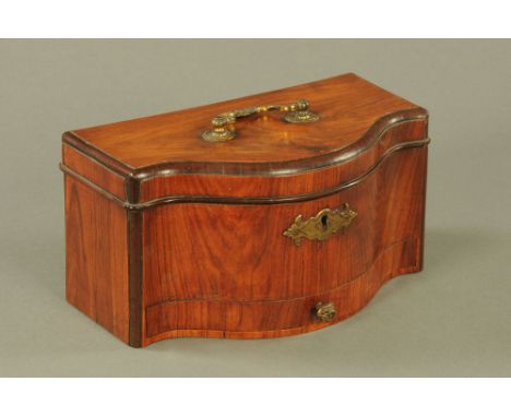 An early George III figured mahogany serpentine fronted tea caddy, the lid with ormolu swan neck handle, fitted single drawer