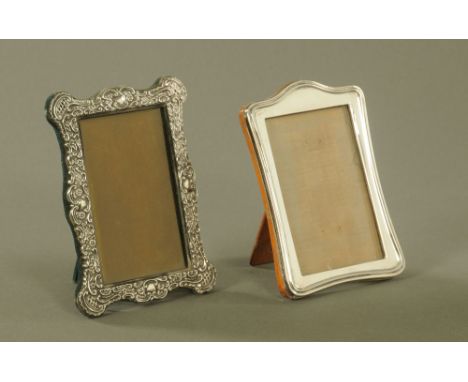 An Edwardian silver photograph frame, Birmingham 1904.  External dimensions 18 cm x 13.5 cm, together with another of plain f