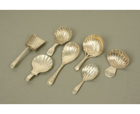 A Victorian cast silver scallop form caddy spoon by Holland, Son & Slater London 1881, a George III silver caddy spoon with i