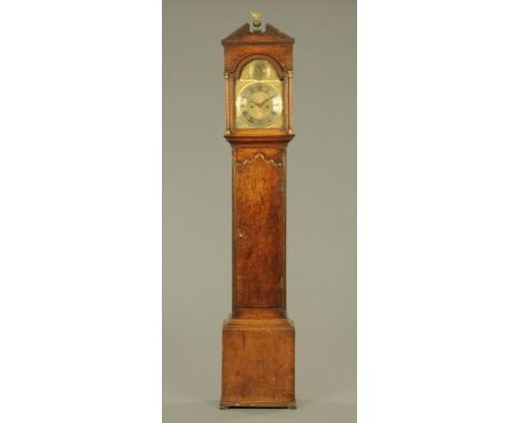 An 18th century oak 8 day longcase clock, by Robert Thwaites of Barnard Castle, having a broken dentil moulded architectural 