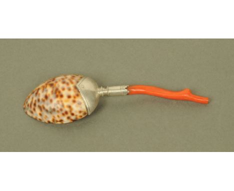 An early 19th century white metal mounted cowrie shell caddy spoon, with red coral terminal. CONDITION REPORT: This spoon is 