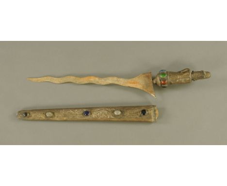 An eastern embossed metal and coloured glass/hardstone set dagger, the associated blade of Kris style, with scabbard.  58 cm 