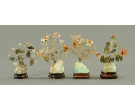 Four Chinese jade and hardstone models, on hardwood bases.   Smallest 15 cm, largest 17 cm high.    CONDITION REPORT: Some ch