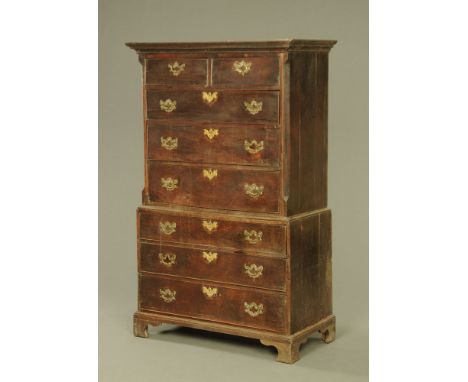 A George III oak chest on chest, with moulded cornice, the upper part with canted front corners, fitted two short and six lon