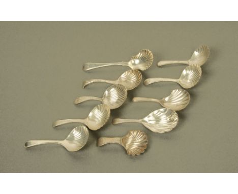Four George III silver caddy spoons, with scalloped bowls (two incompletely marked with purely lion passant and makers mark),
