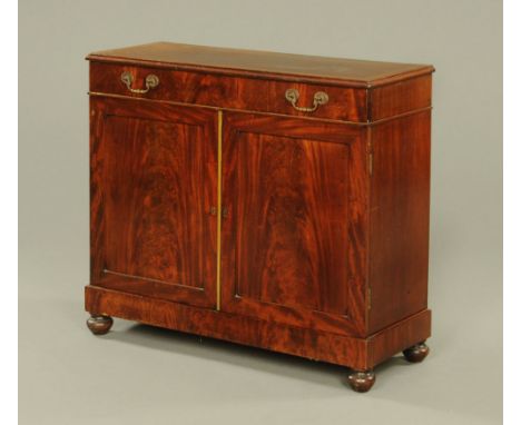 A 19th century chiffonier base, mahogany with drawer above a pair of well figured panelled doors raised on bun feet.  Height 