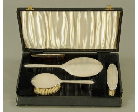 A cased silver mounted dressing set, engine turned two brushes, comb and mirror, 1947.