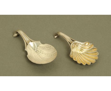 Two George III silver caddy spoons, with scrolled terminals, one with scalloped and silver gilt bowl, probably by Hester Bate