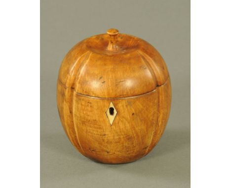 A George III style fruitwood melon form tea caddy, with slice cut corners and ivory lozenge escutcheon. 14 cm high.
