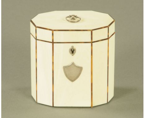A George III ivory decagonal tea caddy, inlaid with tortoiseshell stringing, the front inset with white metal vacant shield c