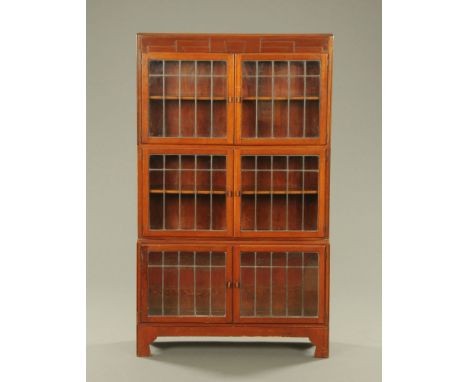 An Art Deco three tier mahogany bookcase, with leaded glass doors.  Height 149 cm, width 89 cm, depth 23 cm. CONDITION REPORT