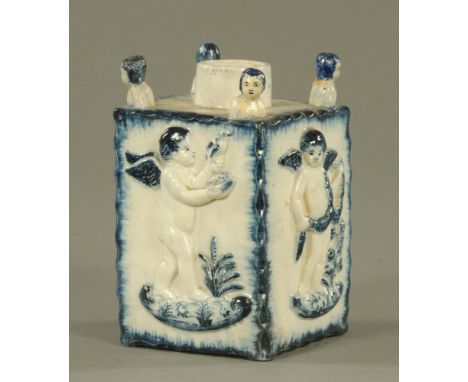 A late 18th/early 19th century blue and white Delftware pottery square sectioned tea caddy, modelled in relief to sides with 