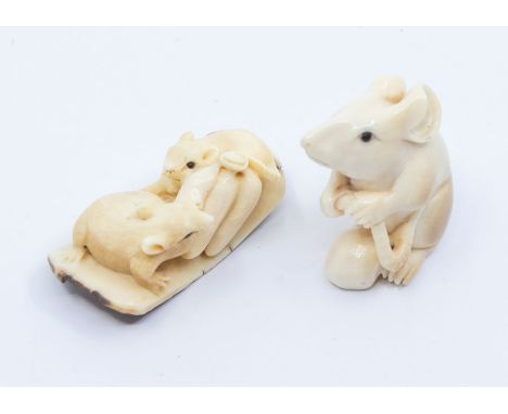 A Japanese ivory netsuke of a mouse, carved with the animal seated holding its tail in both front paws, signed, 3.3cm high, M