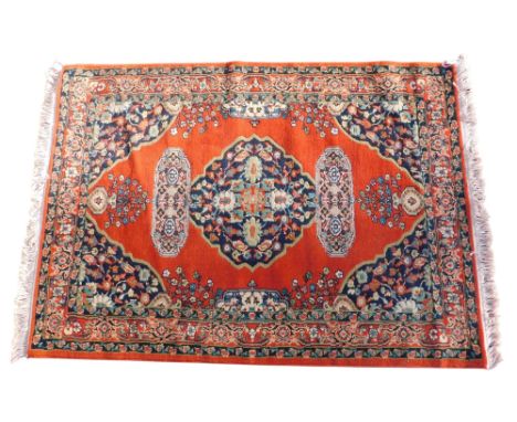 A machine woven Turkish rug, label stating made exclusively for NTC Carpets, with a central medallion on a deep orange ground