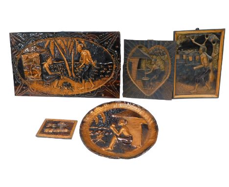A group of African related wares, to include an embossed copper panel depicting a male and female by a cooking pot, 43cm x 72