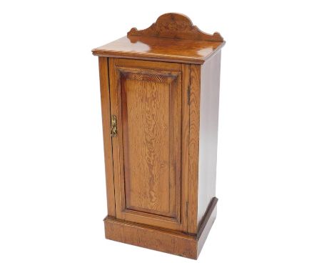 A Victorian pitch pine pot cupboard, with a raised back and a panelled door, on a plinth, 41cm wide. 